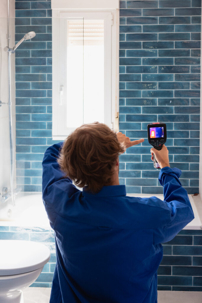 Technician using leak detection tool